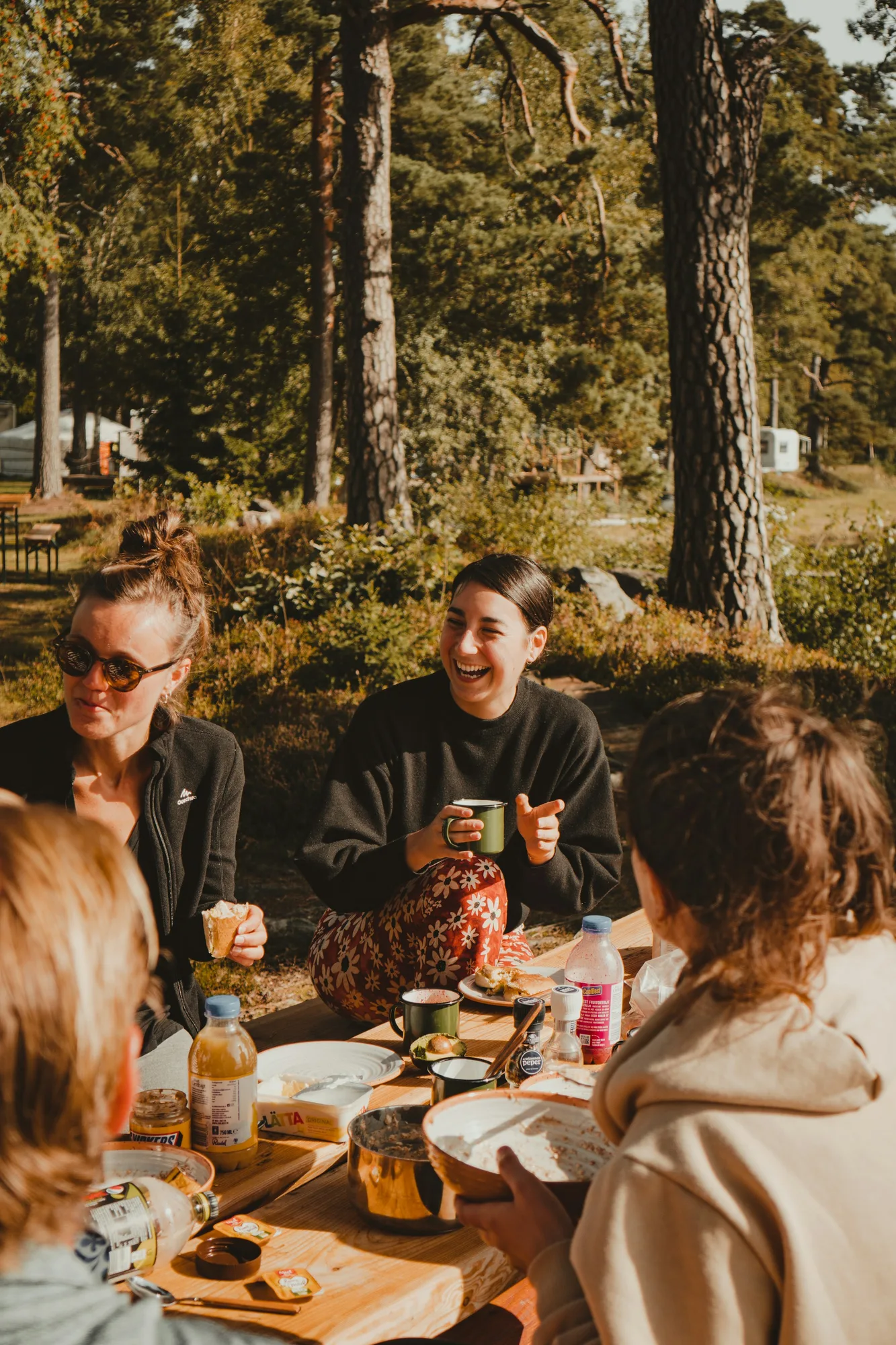 Neighbours sharing a meal at a long table outdoors